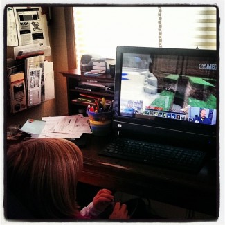 a young girl watches a Minecraft video on YouTube
